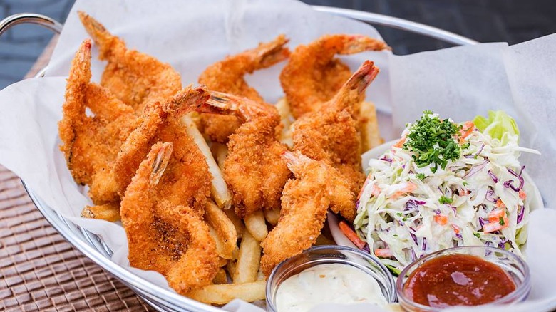 Fried shrimp in bowl with fries and coleslaw
