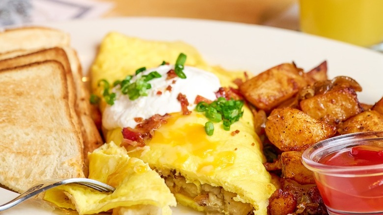 Loaded Mashed Potato Omelette with potatoes, bread, and ketchup