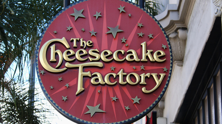 Large Cheesecake Factory sign on building facade of restaurant.