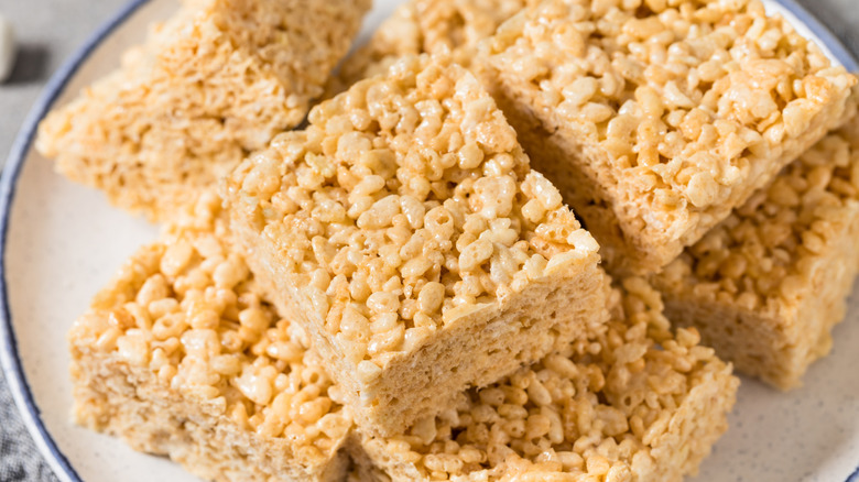 Rice Krispies Treats squares stacked on a white plate