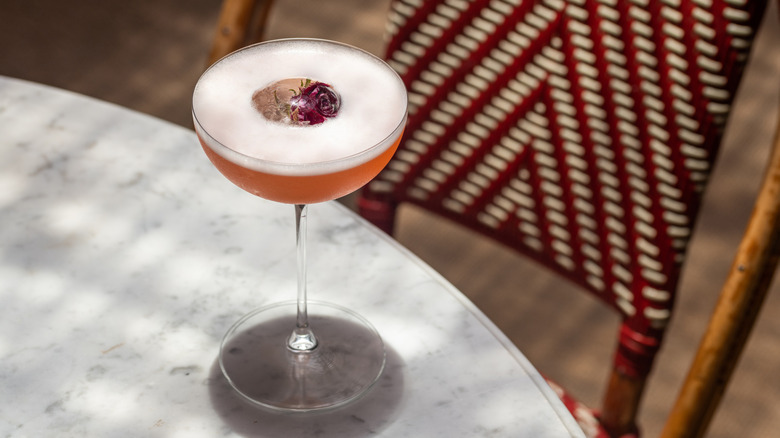 Beauty and the Beast cocktail from LPM Miami on a marble table next to chair