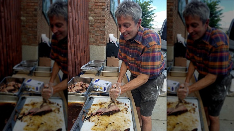 Willie Wagner, owner of The Tonk in Chicago, carves up some barbecue