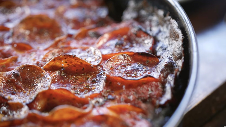 Close-up of Pequod's deep dish pizza still in pan.
