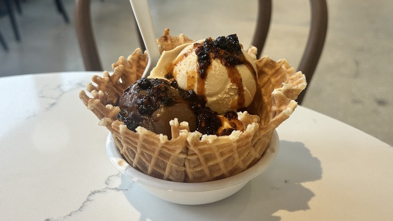 Three scoops of ice cream topped with chili crisp
