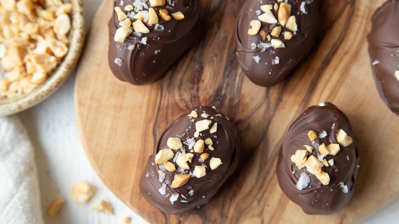 Chocolate covered dates topped with nuts