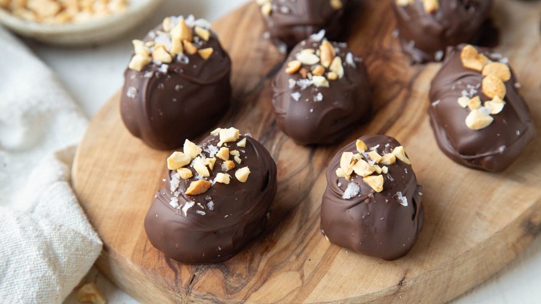 Snickers-style chocolate-covered dates on serving board