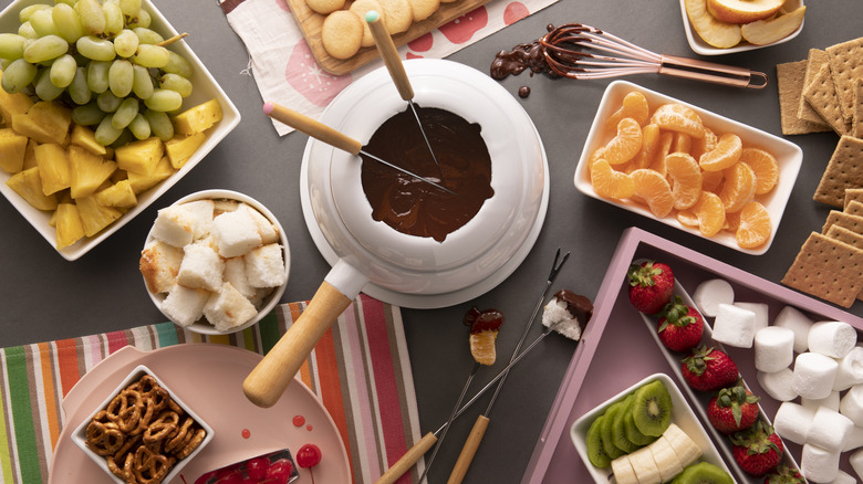 Chocolate fondue with assorted fruits for dipping including pineapple