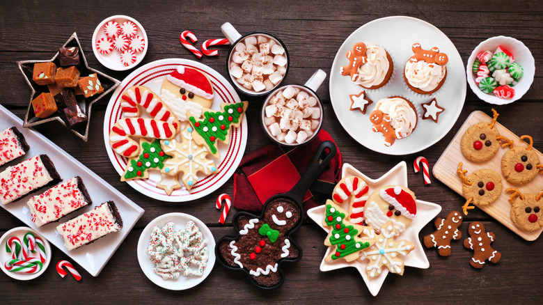 Top view of different Christmas desserts spread on a table.
