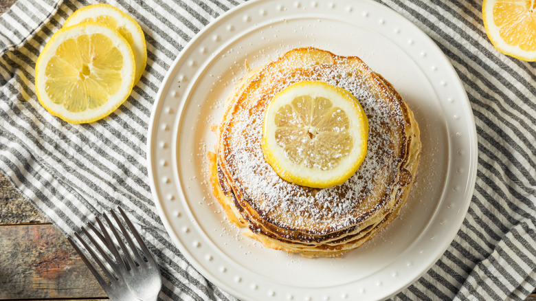 Top view of lemon pancakes with powdered sugar