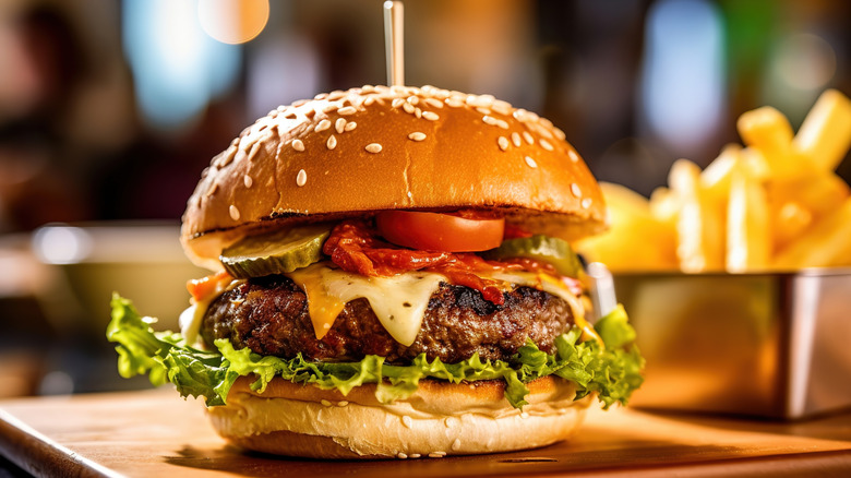 Cheeseburger with tomatoes, pickles, and lettuce