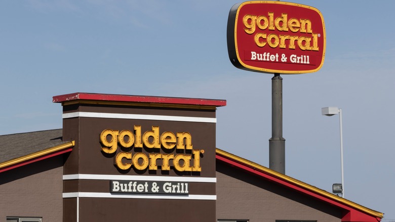 Diagonal view of a Golden Corral restaurant sign and the front of the building