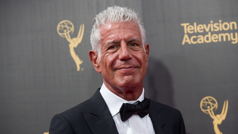 Anthony Bourdain wearing a tuxedo and smiling