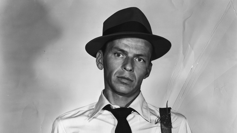 black and white photo of Frank Sinatra wearing a hat and tie