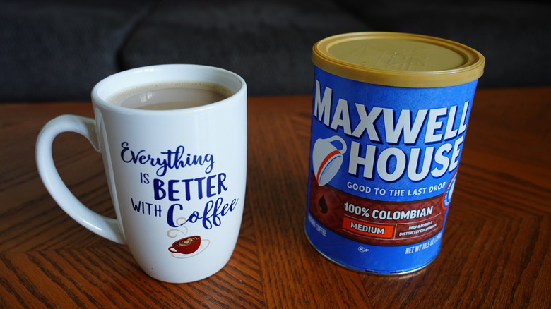 A container of Maxwell House coffee and a mug