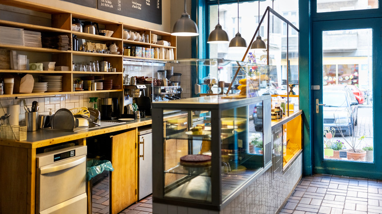 The interior of a small coffee shop with nobody inside of it