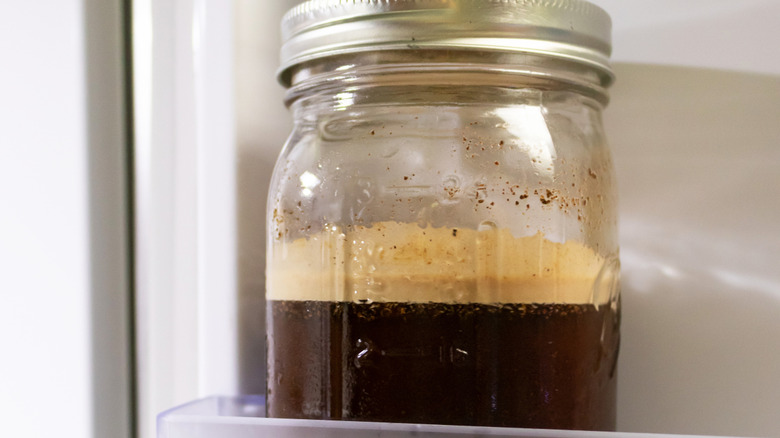 A jar of cold brew coffee in a refrigerator