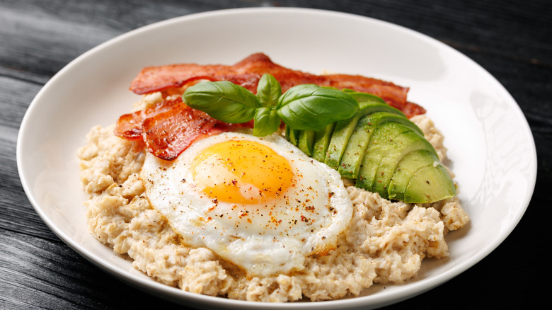 Savory oatmeal with a fried egg, bacon, and avocado