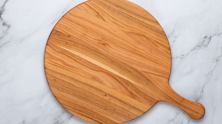 A wooden charcuterie board paddle.