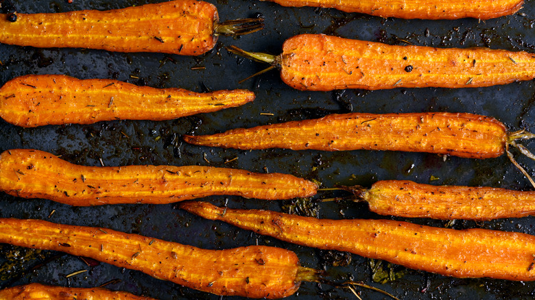 roasted carrots halved lengthwise in pan
