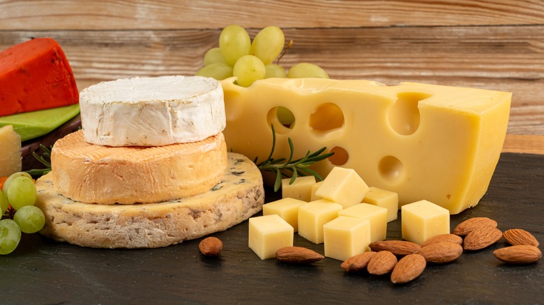 assortment of cheeses with grapes and almonds