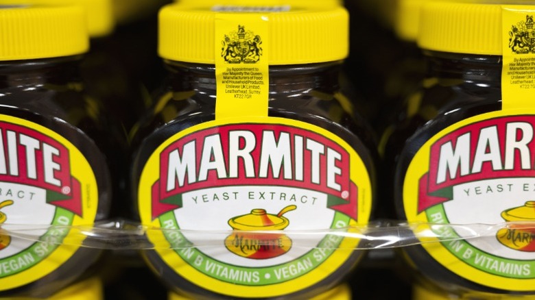 Jars of Marmite on a supermarket shelf.