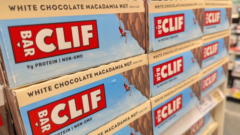 Boxes of White Chocolate Macadamia Nut Clif Bars for sale in a supermarket.