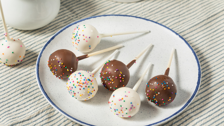 homemade vanilla and chocolate cake pops on a white and blue plate