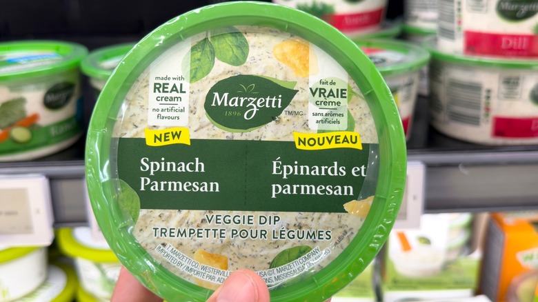 Person holding Marzetti vegetable dip in store