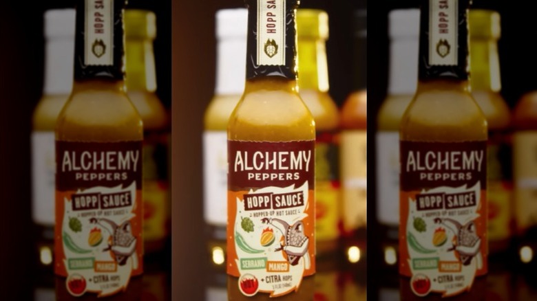 A bottle of Alchemy Peppers Serrano Mango Hopp Sauce.