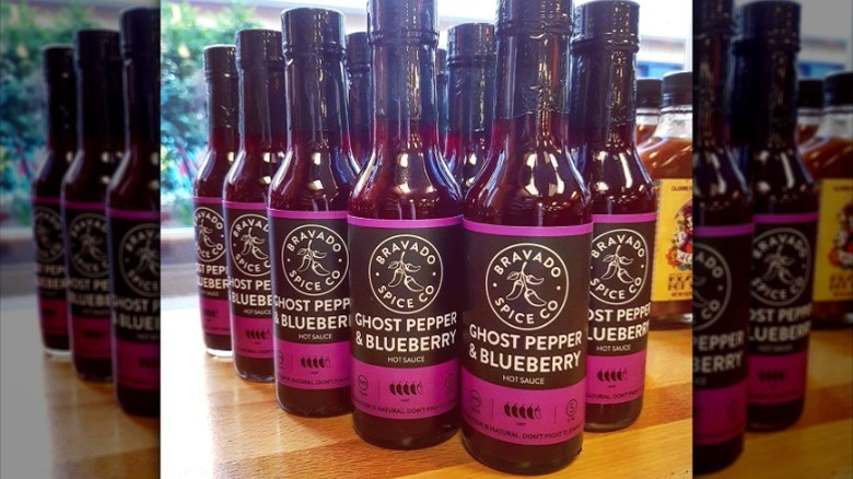Several bottles of Bravado Spice Co. Ghost Pepper and Blueberry Hot Sauce.