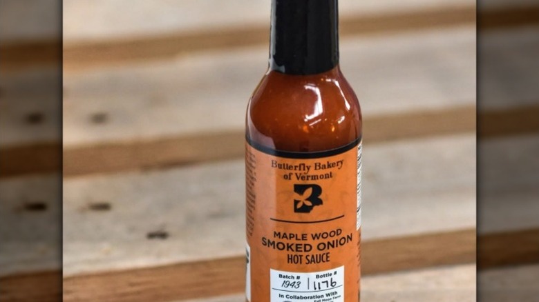 A bottle of Butterfly Bakery of Vermont Maple Wooked Smoked Onion Hot Sauce.