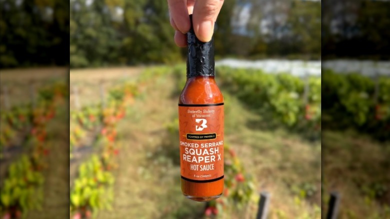 A bottle of Butterfly Bakery Smoked Serrano Squash Reaper X Hot Sauce.