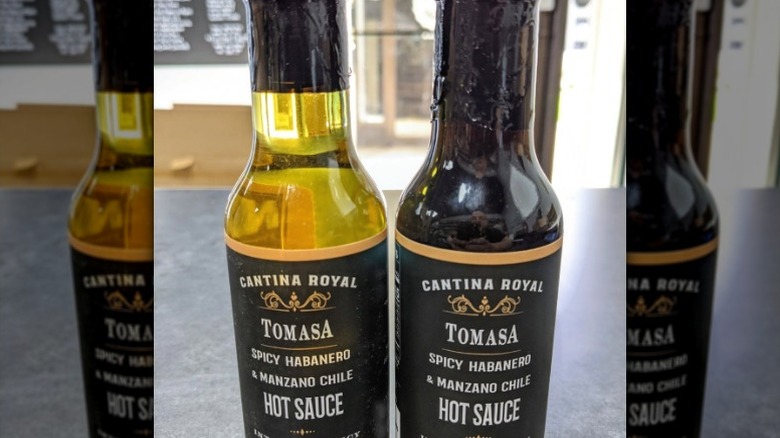 Two bottles of Cantina Royal Tomasa Spicy Habanero & Manzano Chile Hot Sauce.