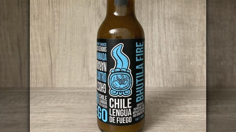 A bottle of Chile Lengua De Fuego Bhutila Fire Hot Sauce.
