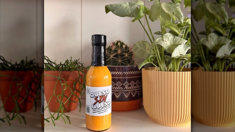 A bottle of Good Heat Queso Sin Queso Hot Sauce.