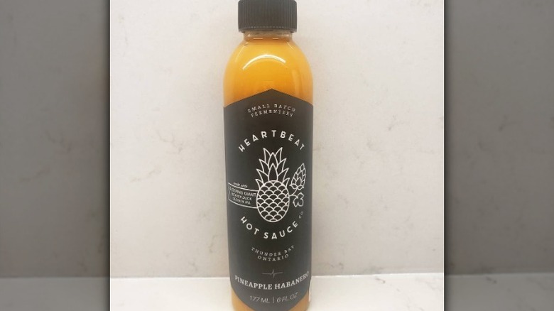 A bottle of Heartbeat Pineapple Habanero Hot Sauce.