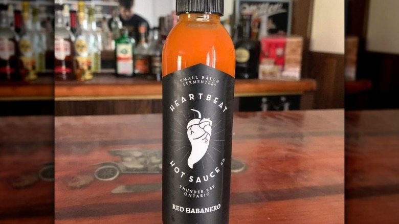 A bottle of Heartbeat Red Habanero Hot Sauce.