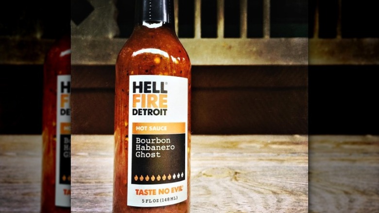 A bottle of Hell Fire Detroit Bourbon Habanero Ghost Hot Sauce.