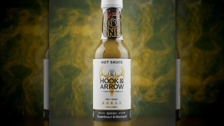 A bottle of Hook & Arrow Spicier Sauerkraut & Mustard Hot Sauce.