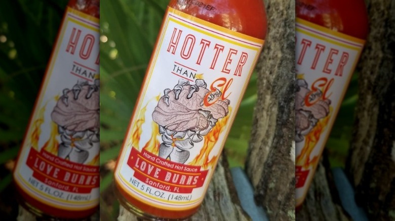 A bottle of Hotter Than El Love Burns Hot Sauce.