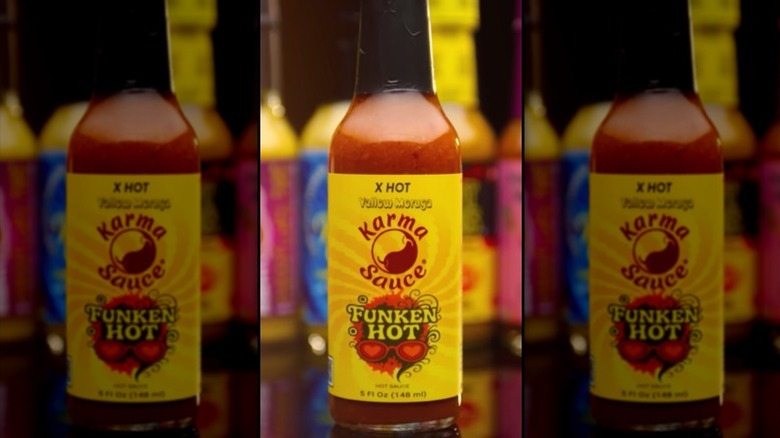 A bottle of Karma Sauce Funken Hot Yellow Edition Hot Sauce.