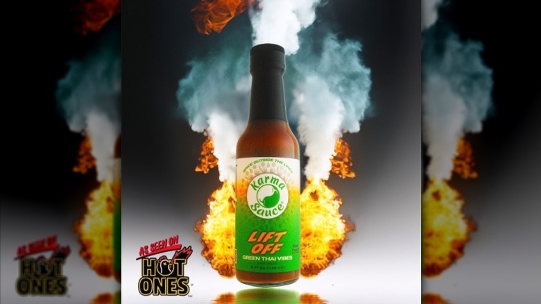 A bottle of Karma Sauce Lift Off Hot Sauce, lifting off.