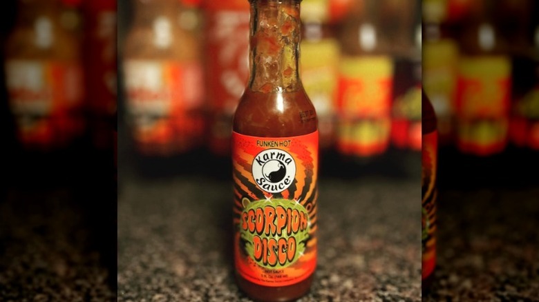 A bottle of Karma Sauce Scorpion Disco Hot Sauce.
