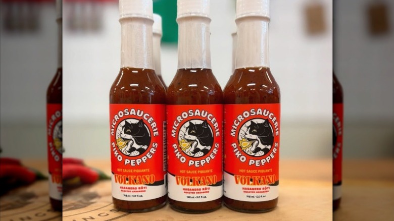 Three bottles of Piko Peppers Volkano Hot Sauce.