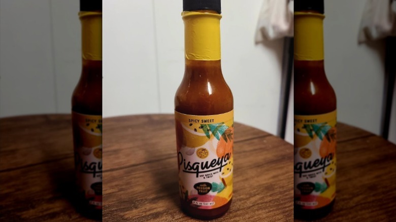 A bottle of Pisqueya Spicy Sweet Passion Fruit Hot Sauce.