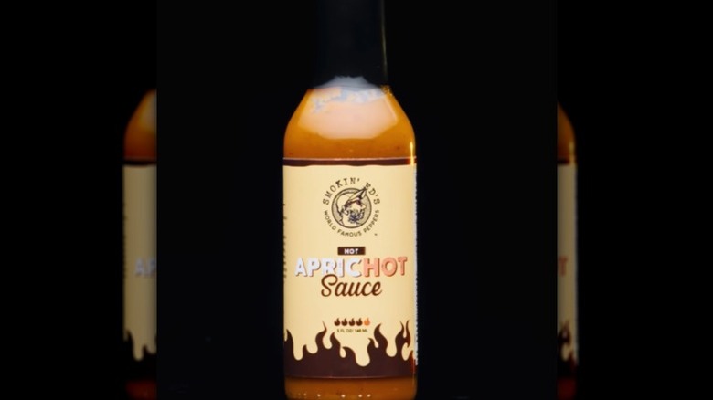 A bottle of Puckerbutt Pepper Co ApricHot Sauce.