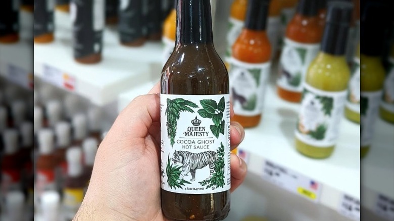 A bottle of Queen Majesty Cocoa Ghost Hot Sauce.