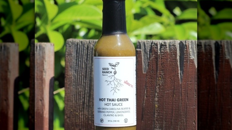 A bottle of Seed Ranch Flavor Co. Hot Thai Green Chili Sauce.