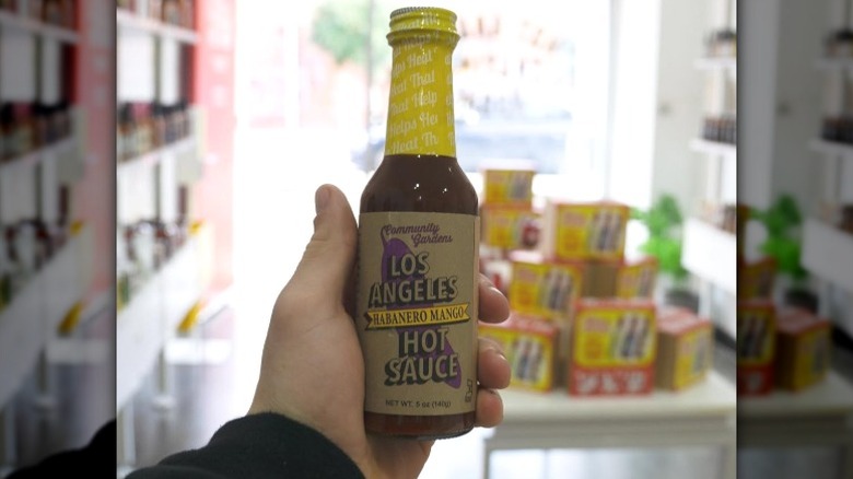 A bottle of Small Axe Peppers Habanero Mango Hot Sauce.