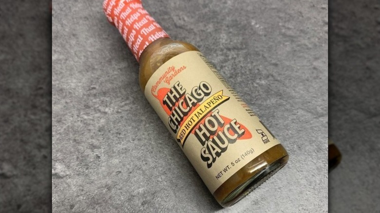 A bottle of Small Axe Peppers The Chicago Jalapeno Hot Sauce.